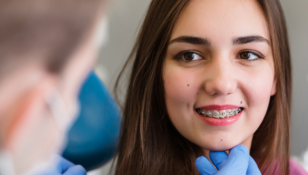 A woman smiling with braces