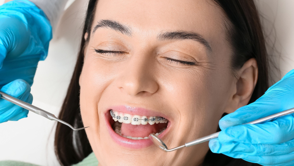 A woman getting her braces adjusted
