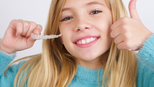 Young kid enjoys benefits of early South Houston braces treatment.
