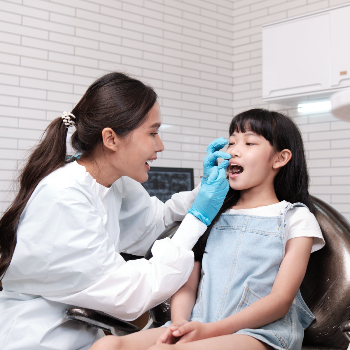 Houston dentist conducts orthodontic evaluation on a child patient.