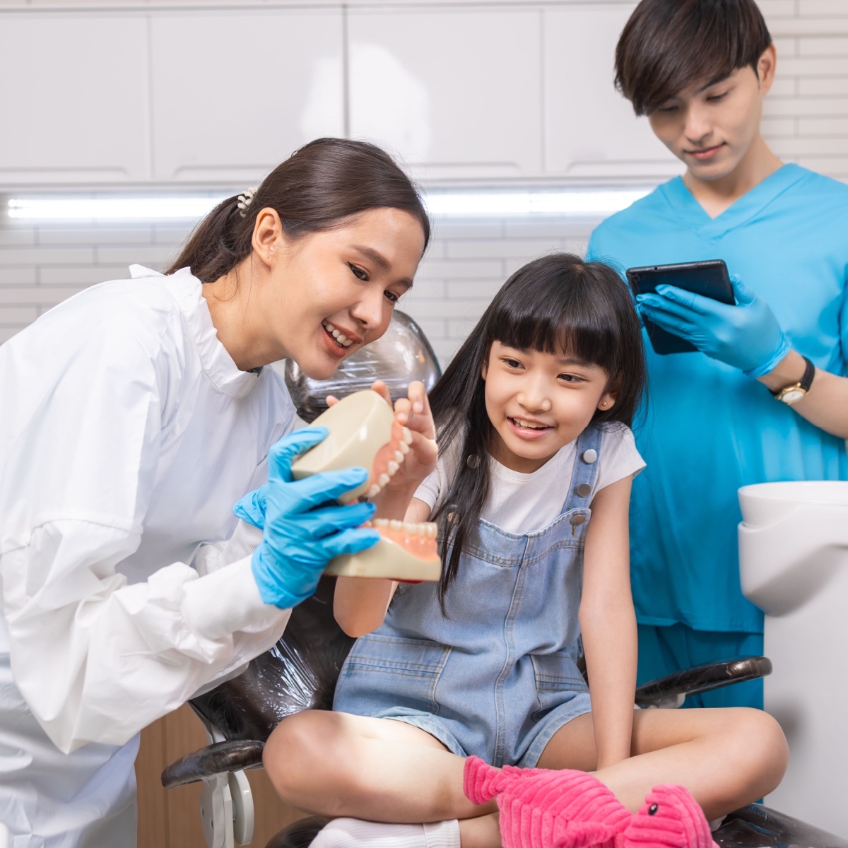 A Houston dentist educating her child patient