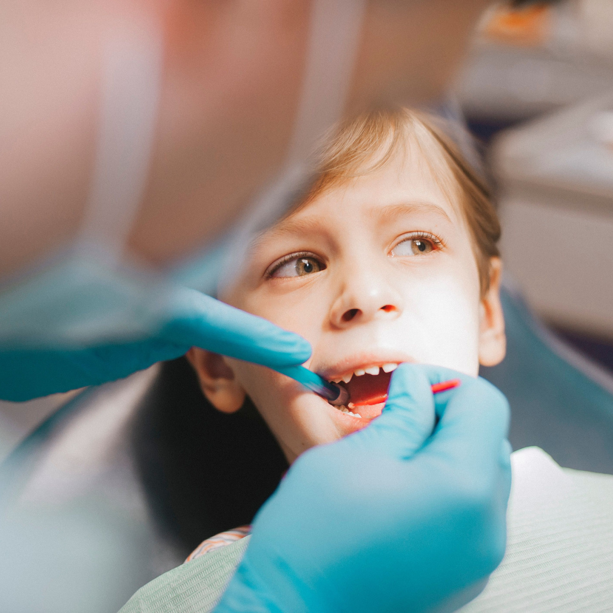 Houston family dentist conducts regular dental checkup on a child.