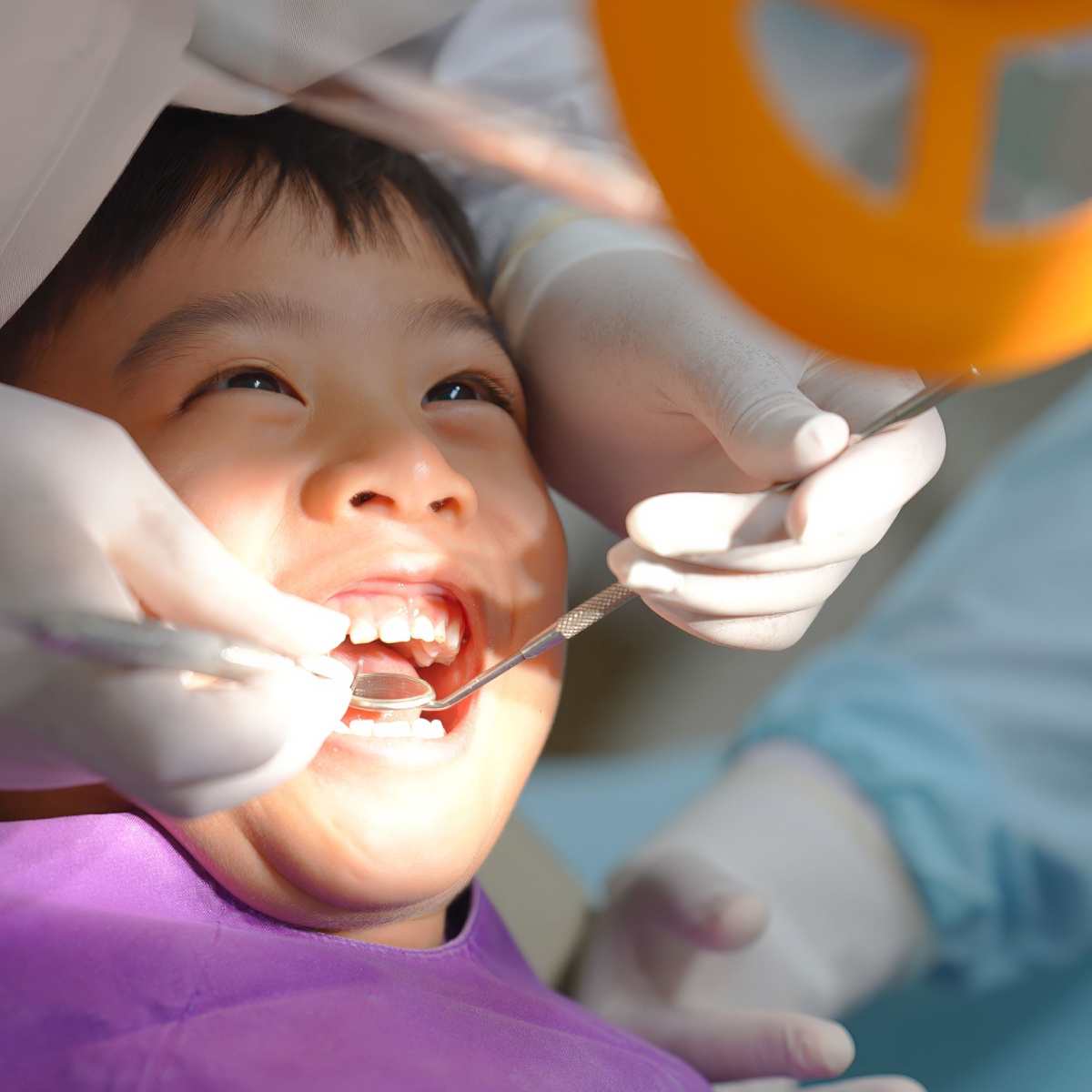 Smiling boy receives treatment from a Houston family dentist.