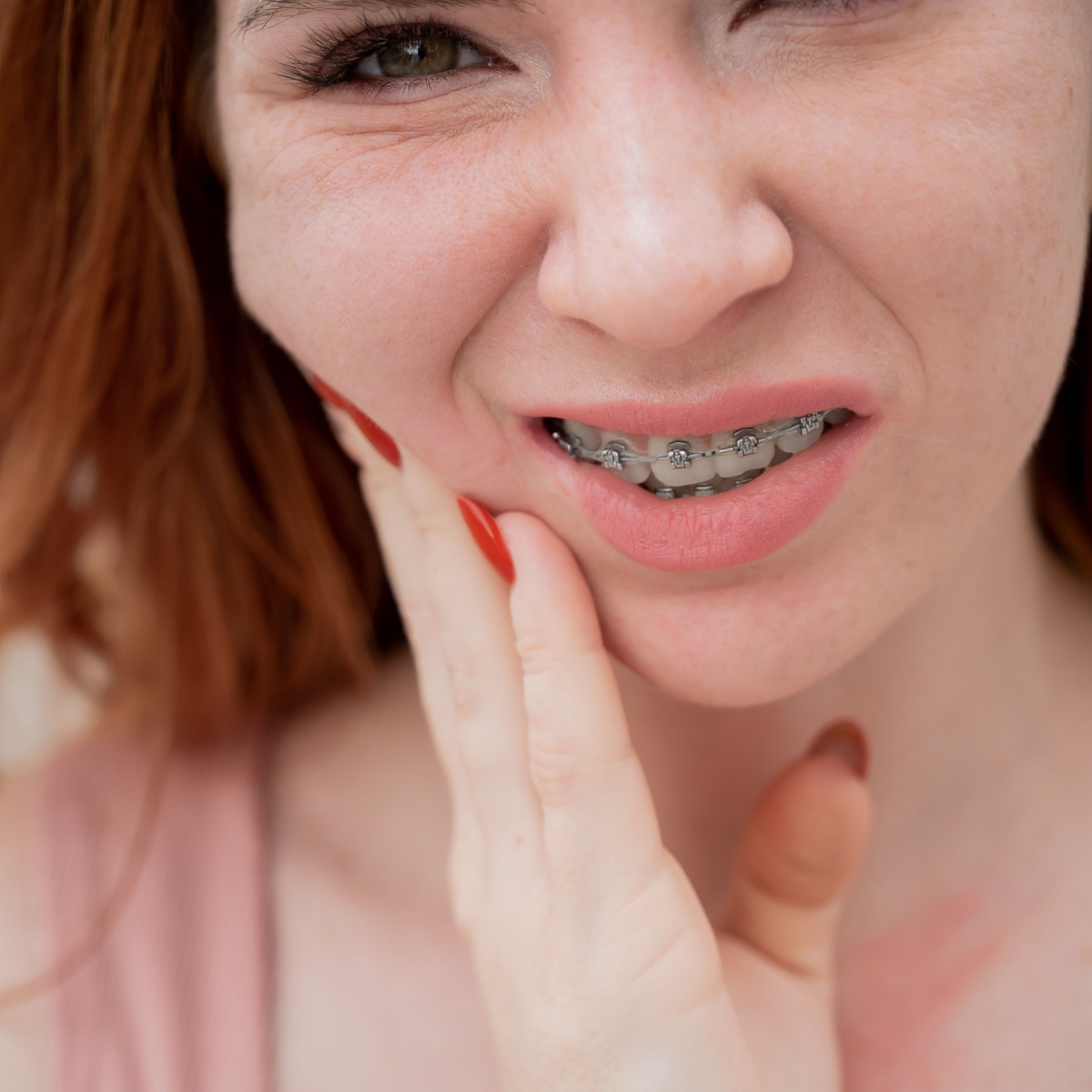 Woman complains of discomfort coming from her dental braces.