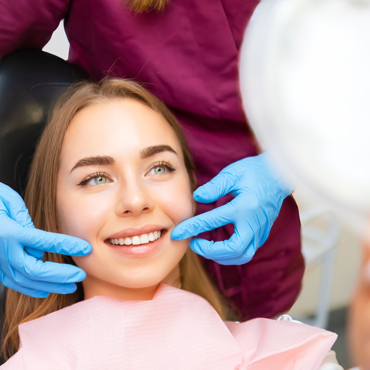 A young woman happy about her teeth whitening treatment