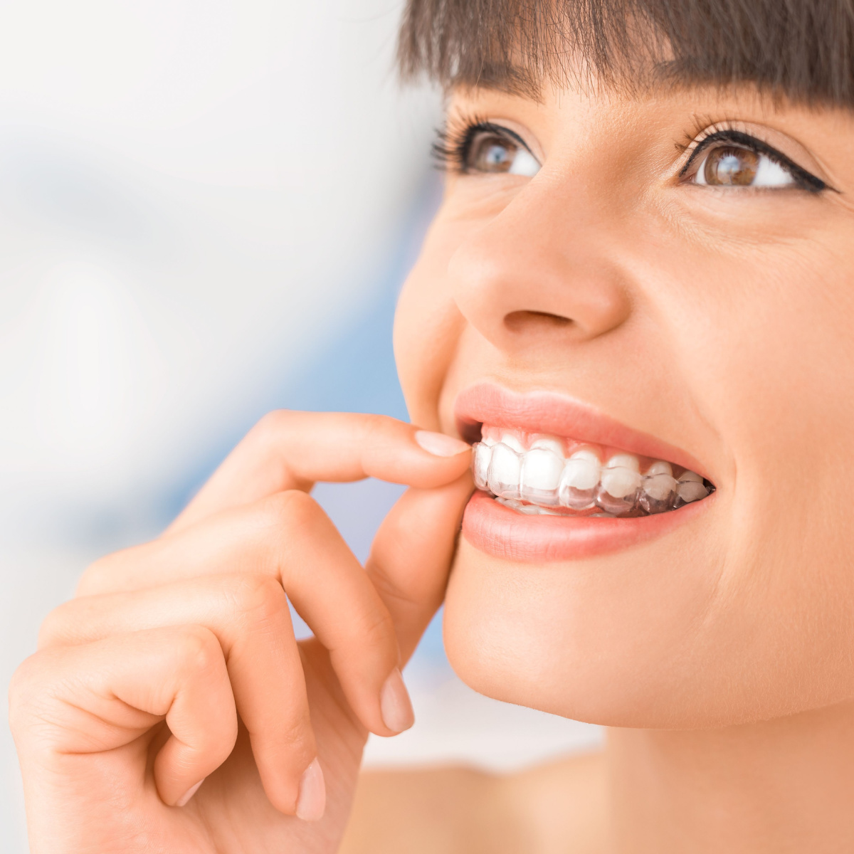 Lady keeps her South Houston Invisalign clean and clear.