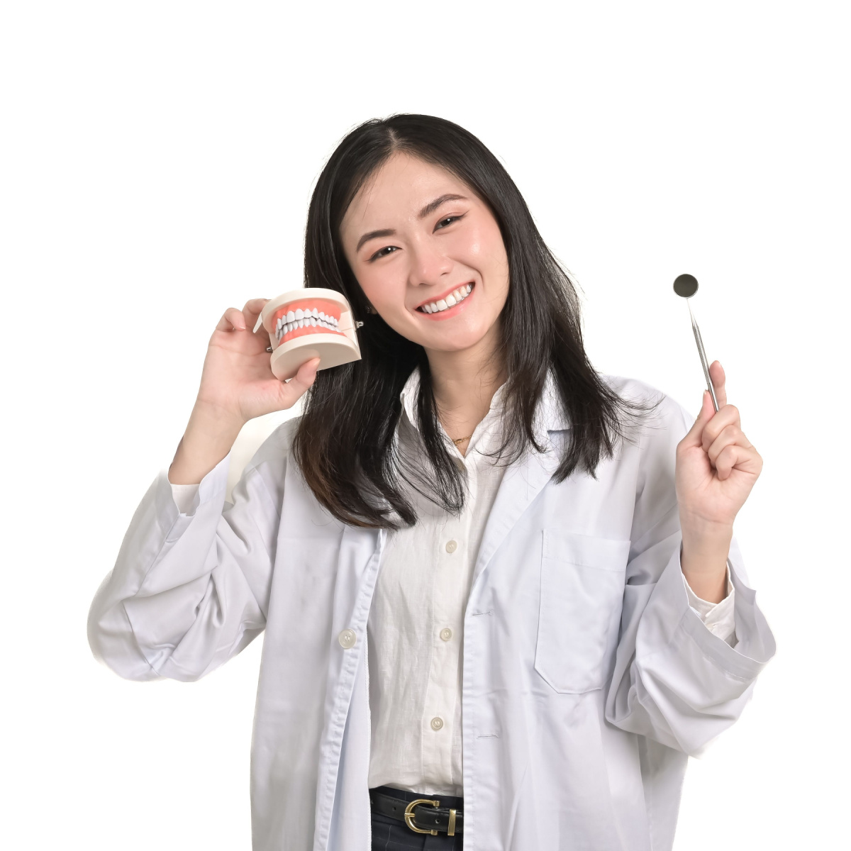 Houston dentist holding teaches brushing techniques.