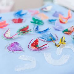 A tray with a variety of Hawley retainers and clear plastic retainers. Ask your South Houston dentist which is best for you after you have completed your Houston braces treatment.