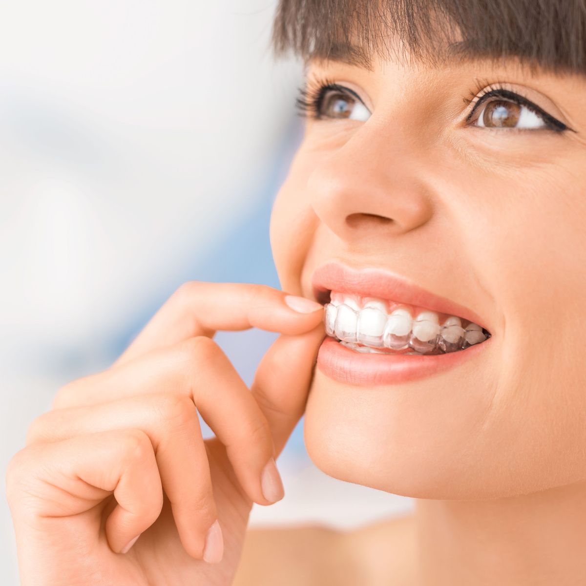 Lady keeps her South Houston Invisalign clean and clear.